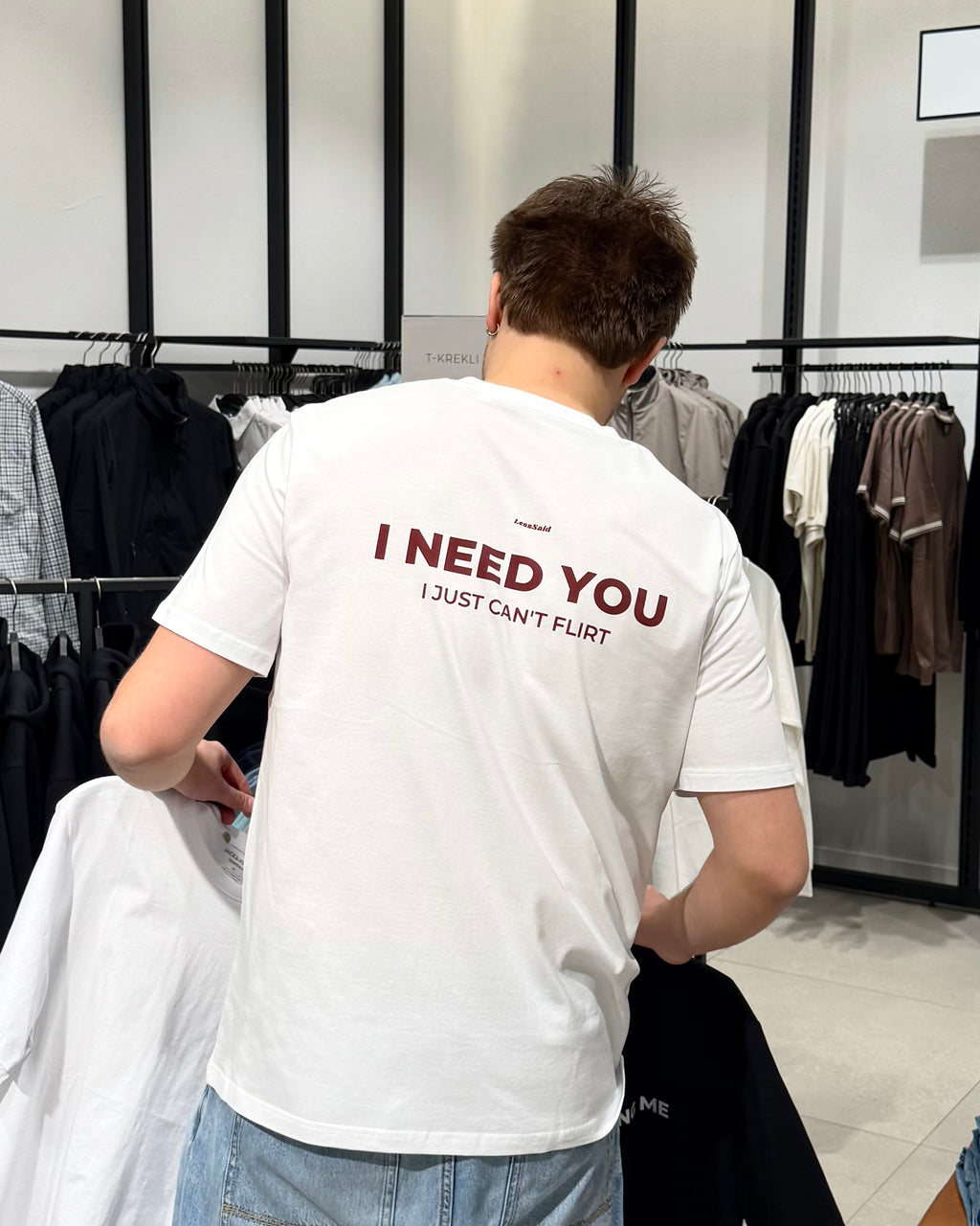 LessSaid "I Need You, I Just Can't Flirt" graphic hoodie with bold text on soft fabric, casual streetwear style.