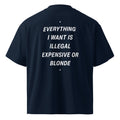 Unisex organic oversized high-neck T-shirt in French navy with bold white text reading "Everything I Want Is Illegal Expensive Or Blonde" by LessSaid.