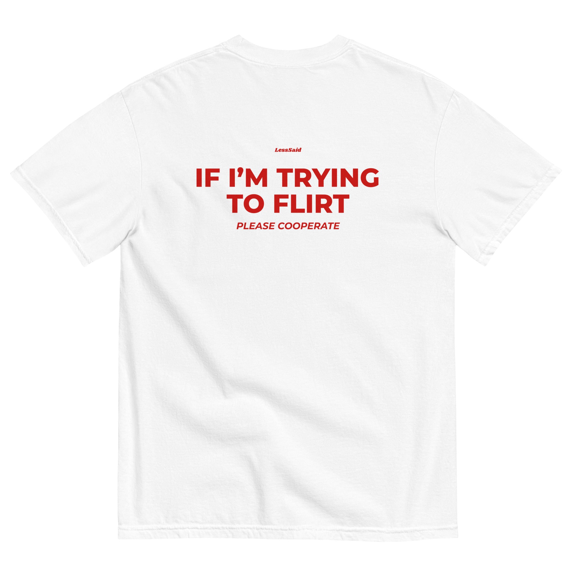 Unisex white heavyweight T-shirt by LessSaid with "If I’m Trying to Flirt Please Cooperate" printed on the back.